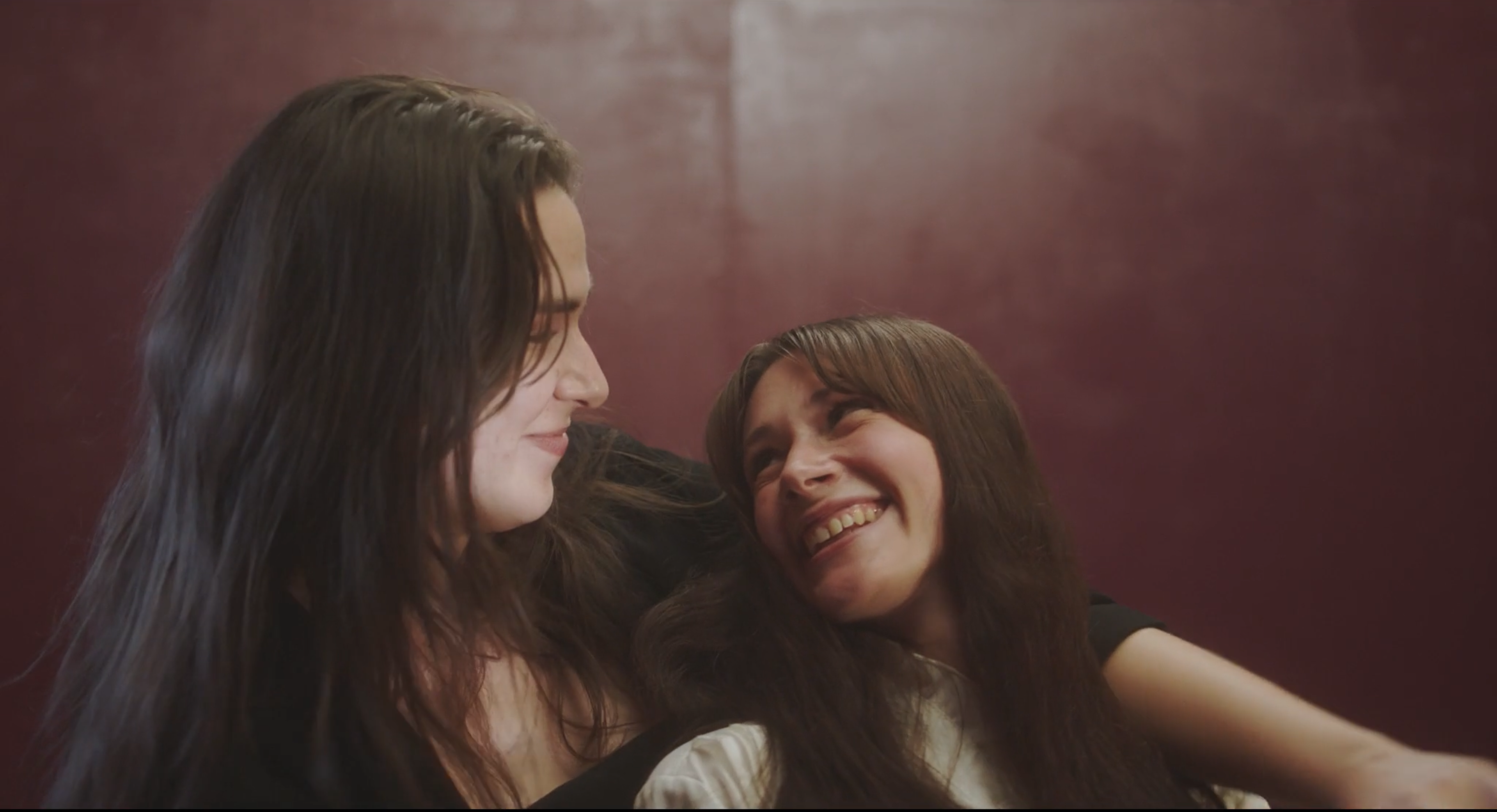 Screenshot from film of a couple embracing